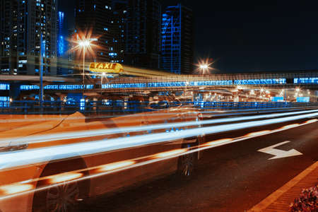 Long exposure of moving cars on night road in Dubai