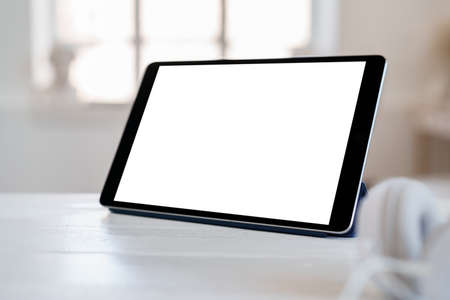 White working table with blank screen digital tabletの写真素材