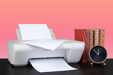 Compact home laser printer against pink background