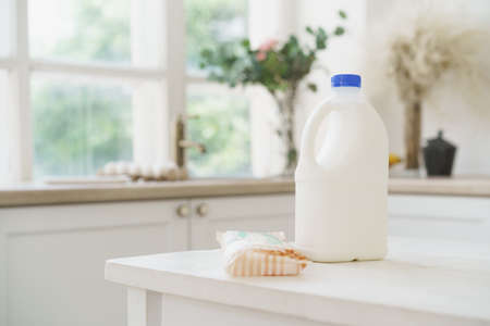 Bottle of milk on white wooden kitchen tableの写真素材