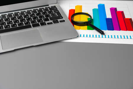 Financial report and laptop on business desk