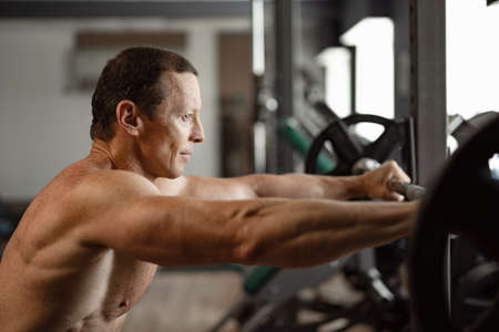 Portrait of a senior muscular man in a gym