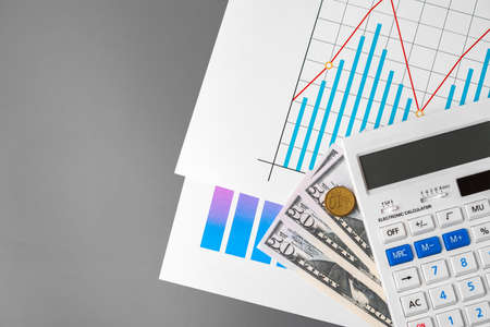 Business graphs paper and calculator on tableの写真素材
