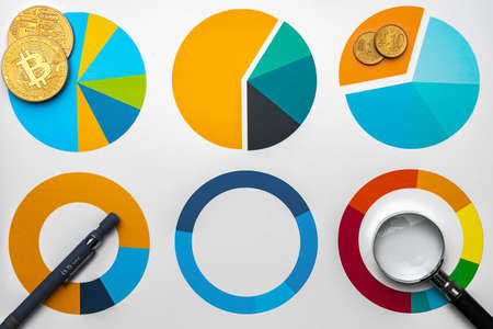 Business graphs and magnifying glass on tableの写真素材