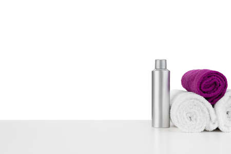 White towels and spa skincare cosmetics on white backgroundの写真素材