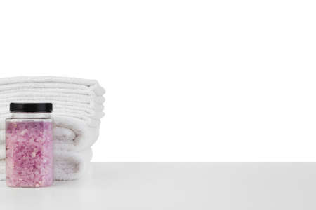 White towels and spa skincare cosmetics on white background
