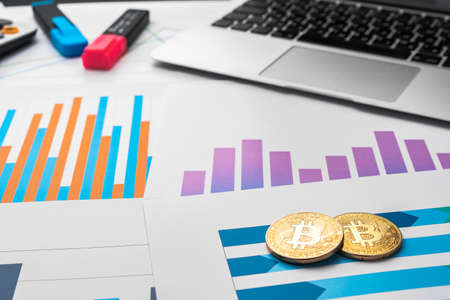 Financial report and laptop on business desk