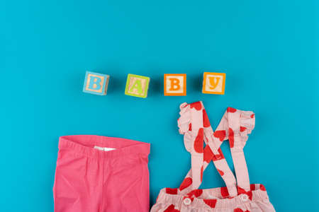 Top view of baby clothes on blue backgroundの写真素材