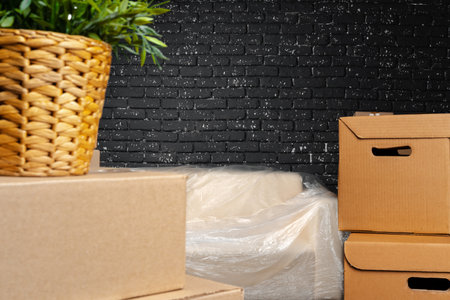 Moving in or moving out concept. Stack of boxes and packed furniture