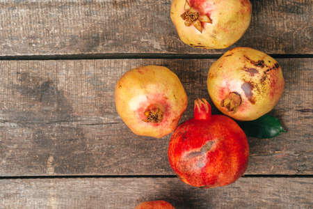 Pomegranate fruit on an old wooden backgroundの写真素材