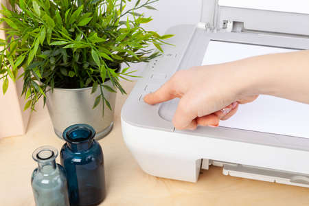 Close up of woman using a printer machine