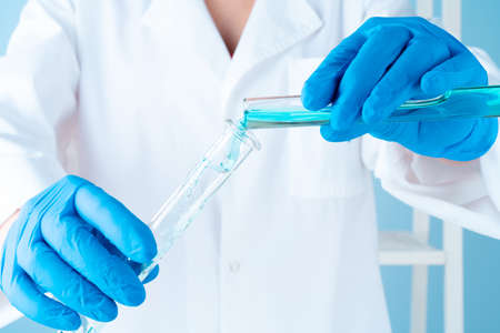 Scientific experiments in a chemistry lab. Color liquids and test tube