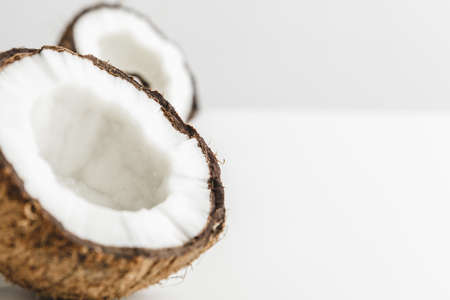 Ripe coconut pieces on white background, copy spaceの写真素材