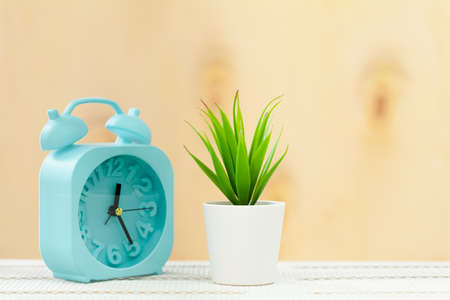 Alarm clock on wooden table close up