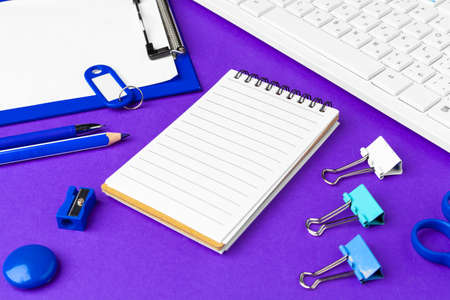 Composition of office lifestyle items on purple background, computer keyboard office supplies on...