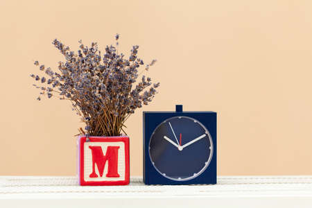 Alarm clock on wooden table close up