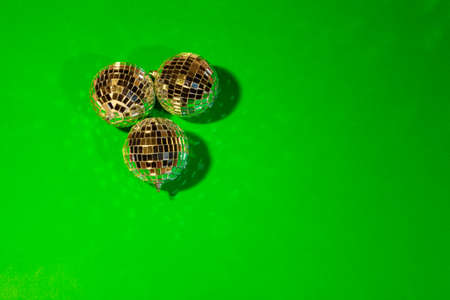 Shiny party disco balls shining in a day light over color backgroundの写真素材