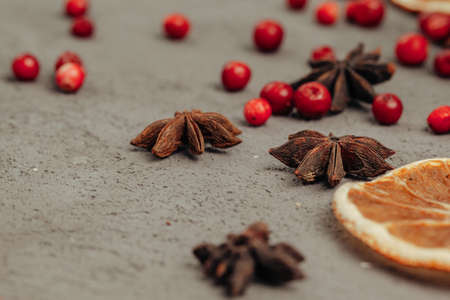 Berries and spices for mulled wine cooking close up on kitchen tableの写真素材
