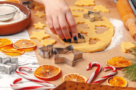 female hands making cookies from fresh dough at homeの写真素材