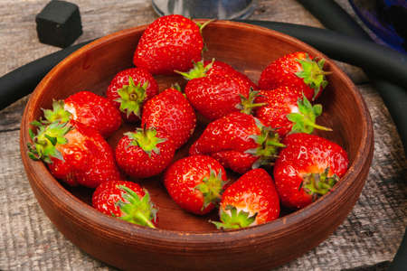 Parts of hookah and fruits on wooden backgroundの写真素材