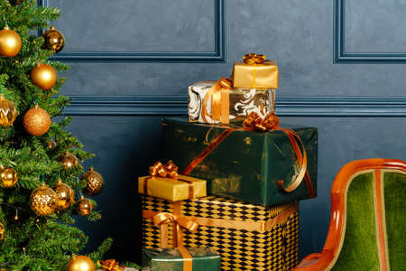 Pile of wrapped green and gold presents for Christmasの写真素材