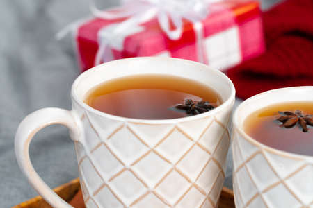 Close up shot of a cups of tea on wooden board at a Christmas interiorの写真素材