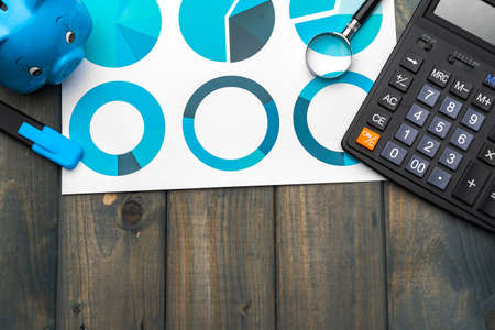 Business graphs paper and calculator on tableの写真素材