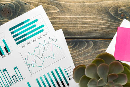 Office workplace table with report pages with financial data