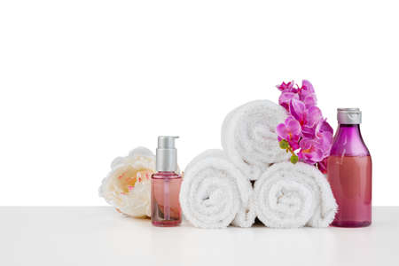 Spa composition with towels and flowers isolated on white