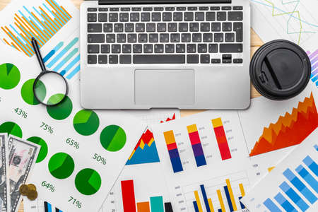 Financial report and laptop on business deskの写真素材