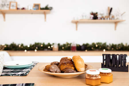 Kitchen table with cookies on plate and honey jarsの写真素材