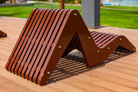 Wooden sun chair on deck at luxury resort