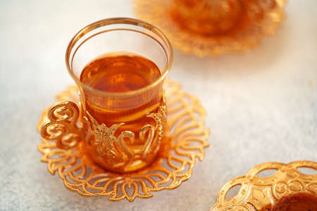Turkish baklava and Turkish tea in oriental dishes on gray backgroundの写真素材