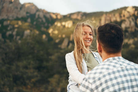 Happy couple man and woman tourists in mountainsの写真素材