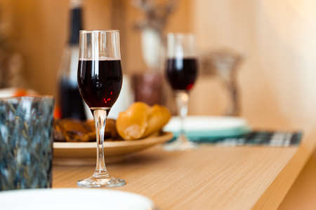 Two glasses with red wine on wooden table