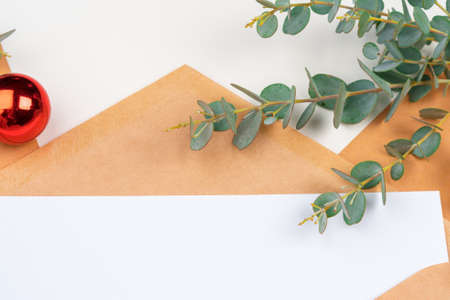 Christmas gift with red bow and greeting card on white wooden backgroundの写真素材
