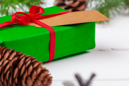 Christmas gift with spruce branches on wooden backgroundの写真素材