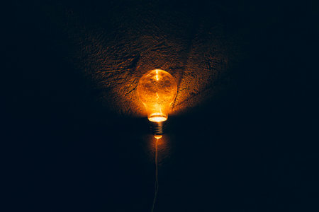 Garland of light bulbs close up in the darkの写真素材
