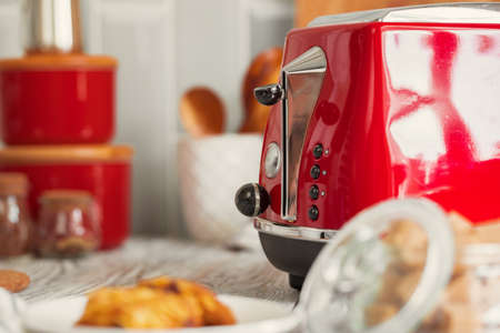 Kitchen shelf with red utensils and dishwareの写真素材