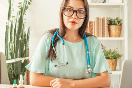 Female medical doctor sitting at her office. Healthcare and medical conceptの写真素材
