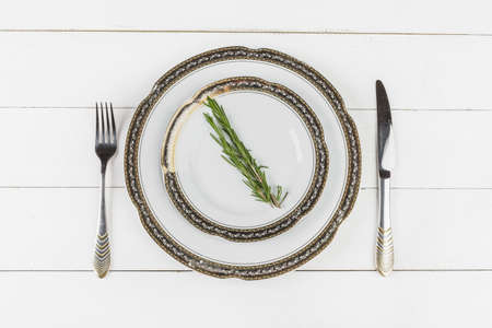 Vintage table setting on wooden table with floral decorの写真素材