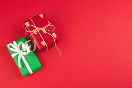 Wrapped gift box on a red background, view from aboveの写真素材