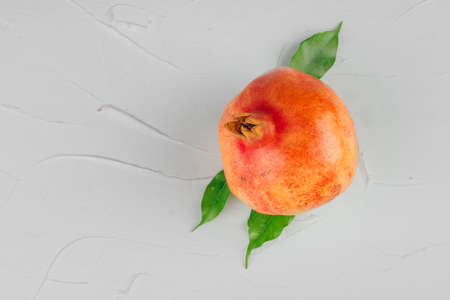 Ripe pomegranates on a light gray kitchen table