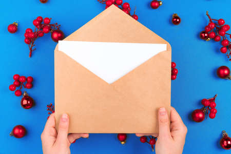 Desk with envelope and Christmas decorations. Flat lay. Mockupの写真素材