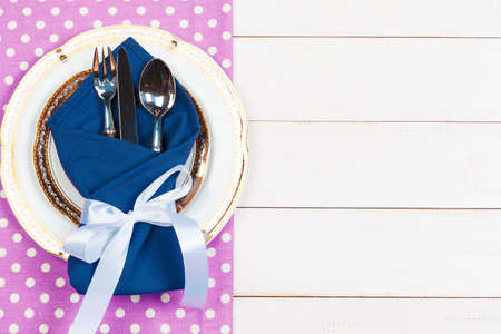 Holiday table setting on wooden table in lilac colorsの写真素材