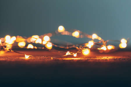 Illuminated garland close up on dark backgroundの写真素材