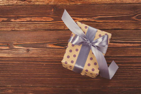 Stylish decorated christmas gifts over brown wooden backgroundの写真素材