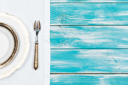 Flat lay of dishware and cutlery on wooden background