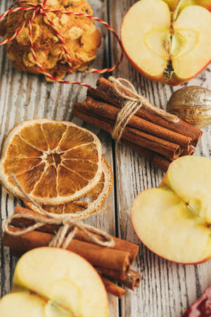 Oatmeal cookies on a old wooden background with cinnamon sticks and decorationsの写真素材