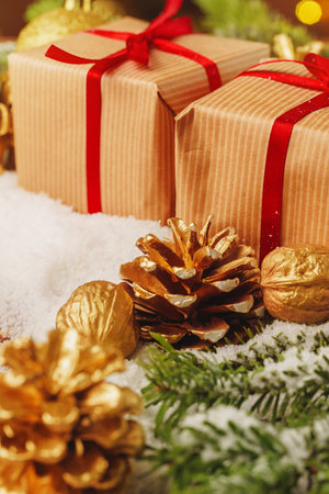 Decorated present on snowy wooden table close up